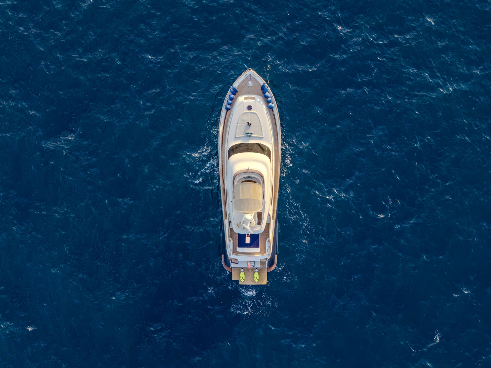 Mochi Craft Dolphin 74 Contango, overhead aerial at anchor on open blue water
