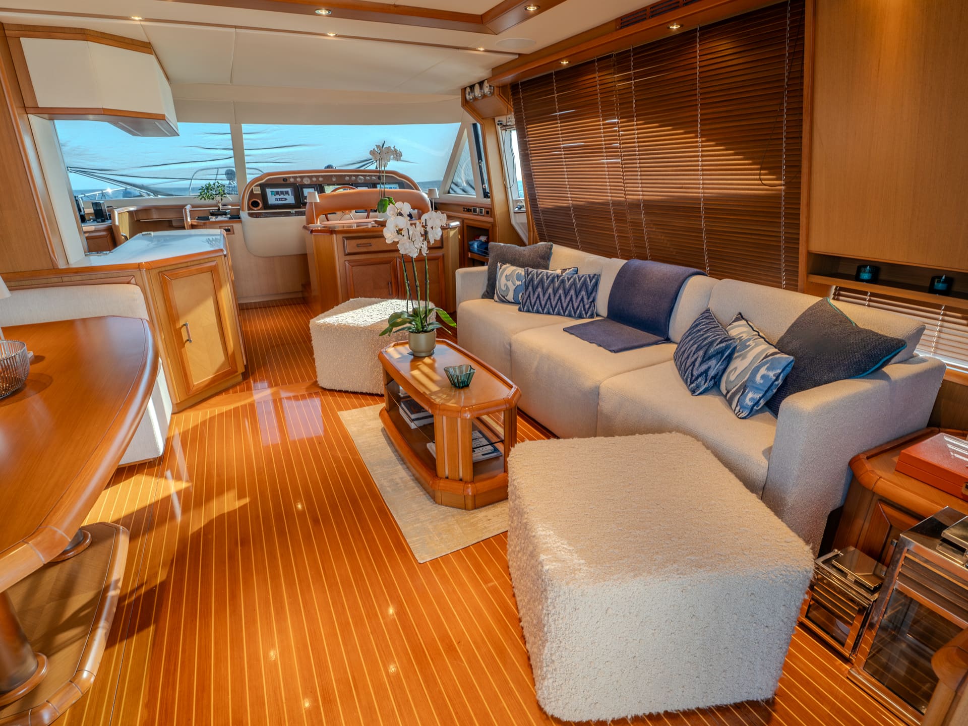 Mochi Craft Dolphin 74 Contango, main salon seating in teak and pale upholstery