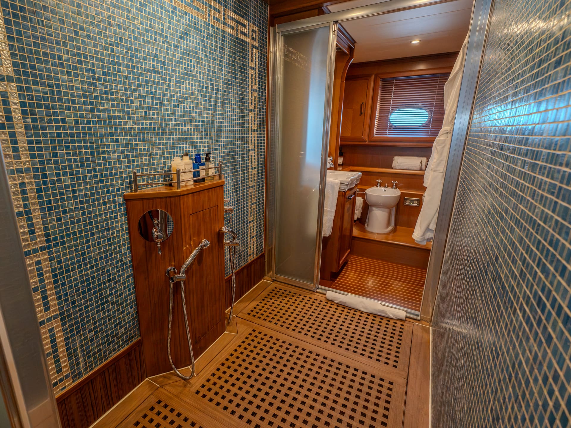 Mochi Craft Dolphin 74 Contango, en-suite shower in mosaic tile with a teak grating