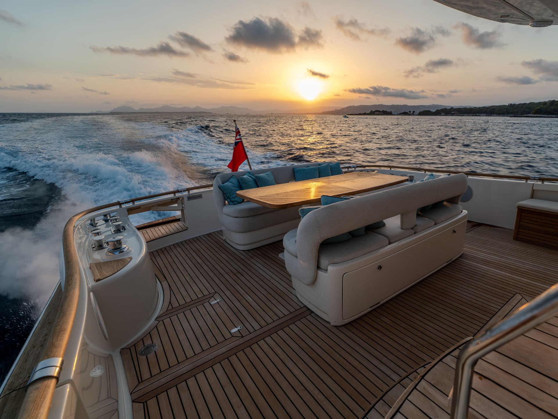 Mochi Craft Dolphin 74 Contango, flybridge under way at sunset